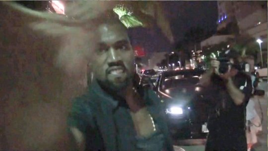 Video of Kanye West grabbing a female paparazzi camera when she asks Kim a Reggie Bush question [video]