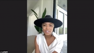LeToya Luckett sitting on couch with hat
